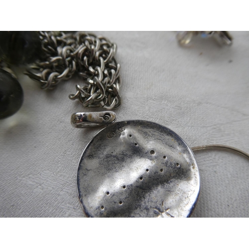 110 - An assortment of various costume jewellery in studio glass dish.