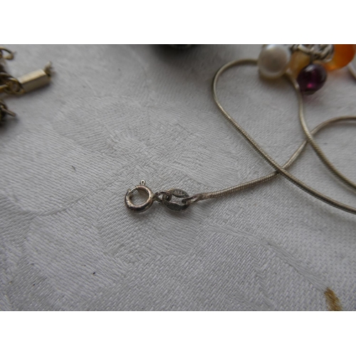 110 - An assortment of various costume jewellery in studio glass dish.