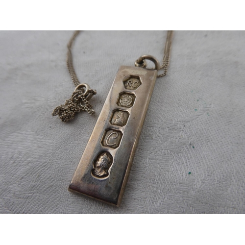 141 - A sterling silver ingot pendant on chain