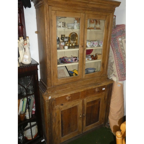 192 - A stunning antique pine two door kitchen cabinet with glass front doors.