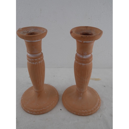 216 - A pair of earthenware candlesticks.