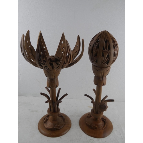 217 - A pair of wooden lotus flower candlesticks.