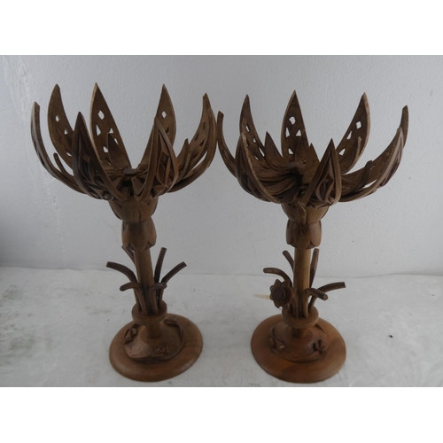 217 - A pair of wooden lotus flower candlesticks.