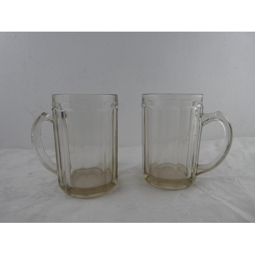 257 - A pair of vintage glass beer tankards.