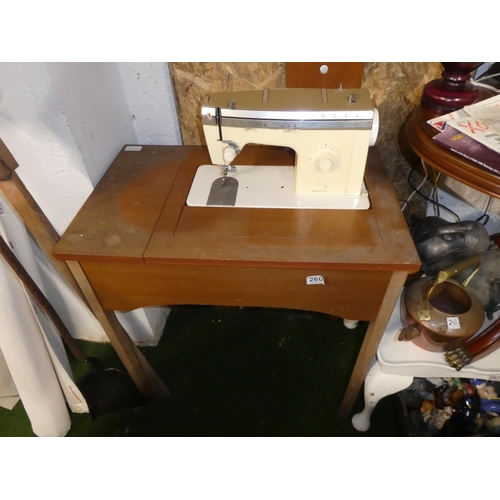 260 - A vintage Singer sewing machine and work table.