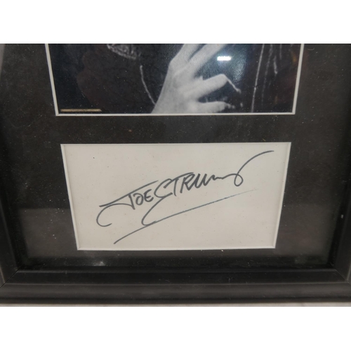 275 - A framed photograph and autograph of Joe Strummer of the Clash.