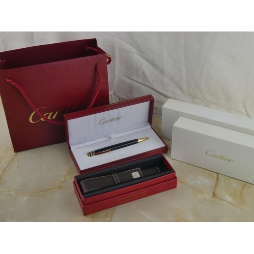 122 - A stunning 'Cartier' pen and leather holder in original presentation boxes and paper bag.