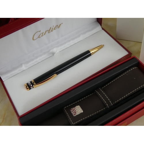 122 - A stunning 'Cartier' pen and leather holder in original presentation boxes and paper bag.