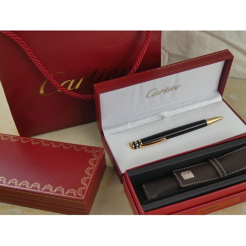 122 - A stunning 'Cartier' pen and leather holder in original presentation boxes and paper bag.