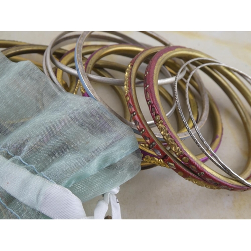 129 - A large collection of assorted bangles.