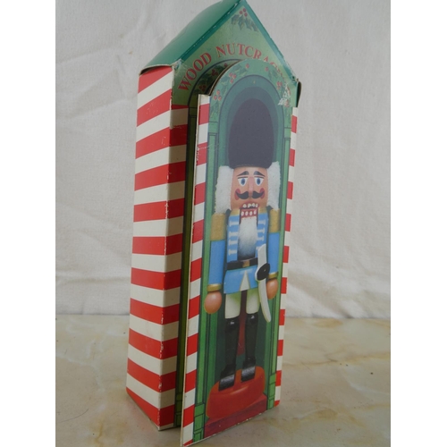 139 - A vintage wooden nutcracker figurine in its original box.