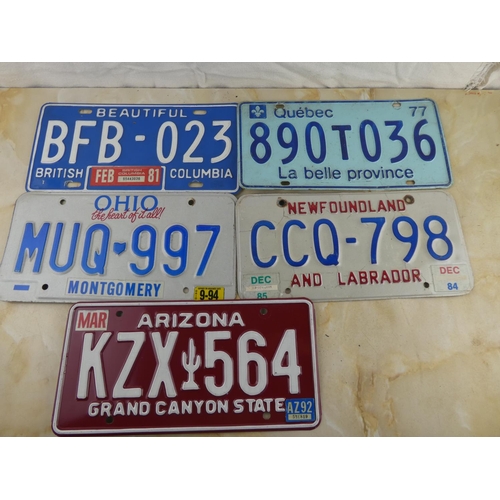 155 - A collection of five vintage American licence plates.