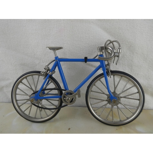 157 - A miniature diecast bicycle with rubber tyres.