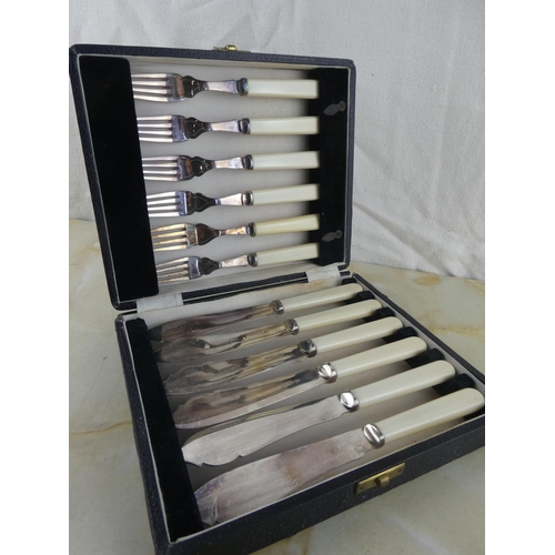 161 - A cased set of silver plated pastry knives and forks.
