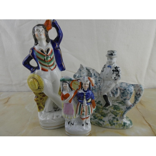 162 - A collection of three Staffordshire figurines.