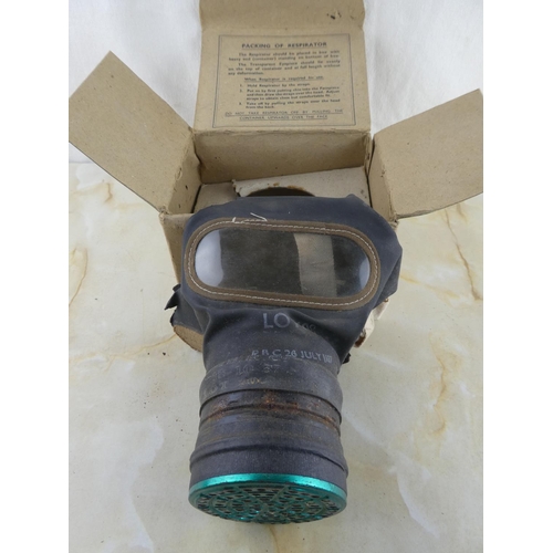 164 - An antique gas mask dated 26 July 1937 and original box.