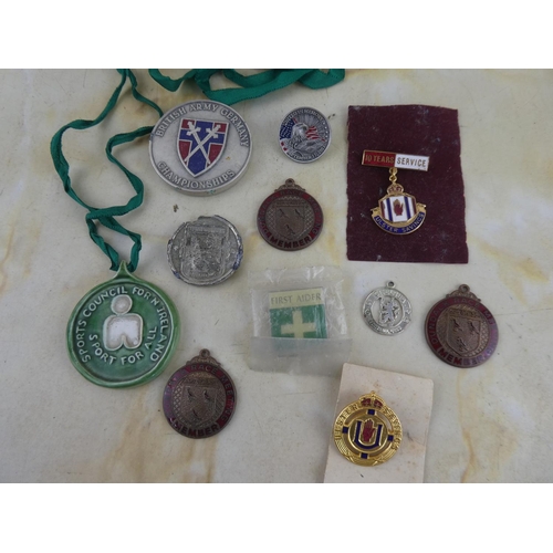 174 - An assorted lot of medals, badges and more.