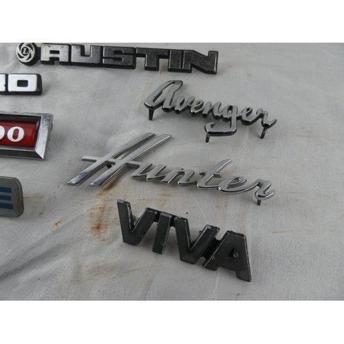 102 - A collection of car badges to include Avenger, Morris 1300, Allegro, Viva, Deluxe, Austin, Hunter.