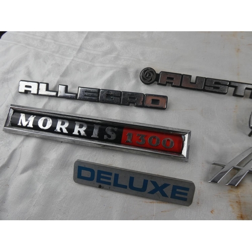 102 - A collection of car badges to include Avenger, Morris 1300, Allegro, Viva, Deluxe, Austin, Hunter.