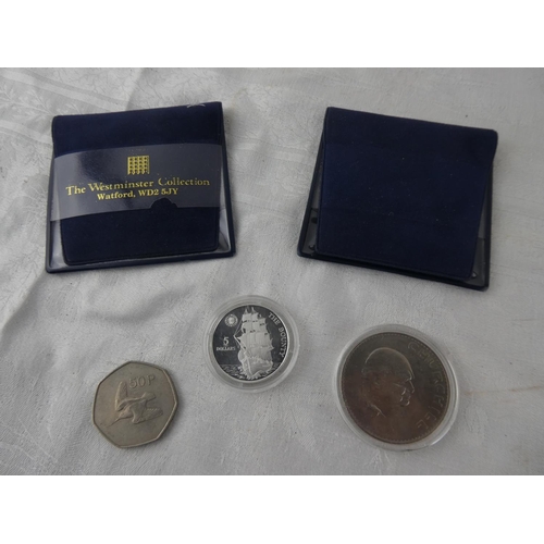 104 - Two Westminster Collection coins 'The Bounty' and 'Churchill' and an old Irish 50p coin.