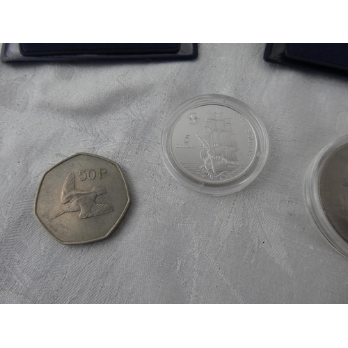 104 - Two Westminster Collection coins 'The Bounty' and 'Churchill' and an old Irish 50p coin.