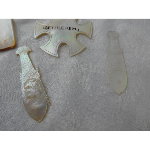 105 - A collection of antique Mother of Pearl gaming tokens.