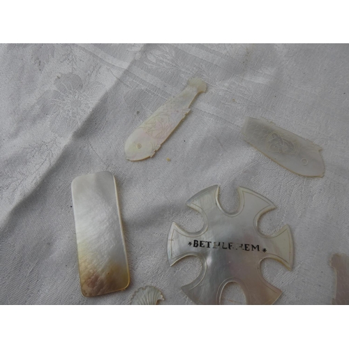 105 - A collection of antique Mother of Pearl gaming tokens.