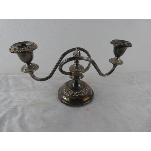 113 - A two branch silver plated candleabra.