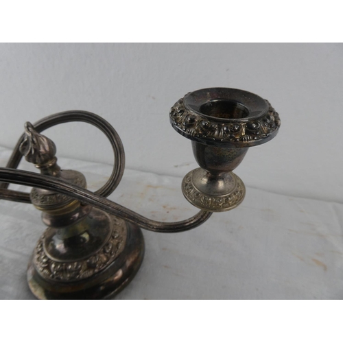 113 - A two branch silver plated candleabra.