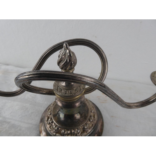 113 - A two branch silver plated candleabra.