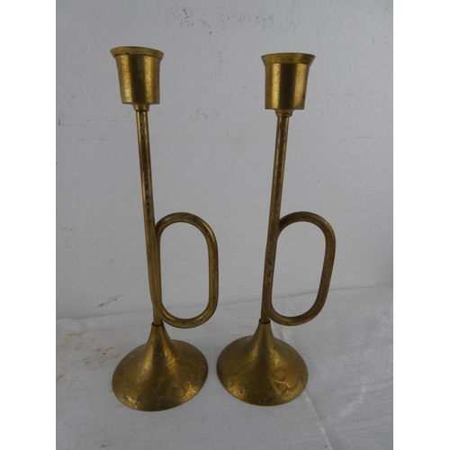 116 - An unusual pair of brass trumpet style candlesticks.