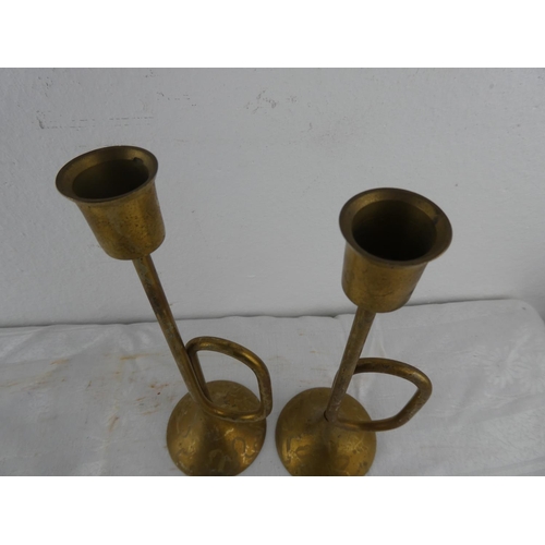 116 - An unusual pair of brass trumpet style candlesticks.