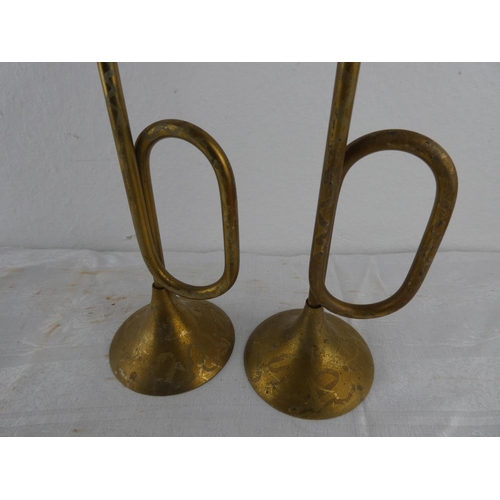 116 - An unusual pair of brass trumpet style candlesticks.