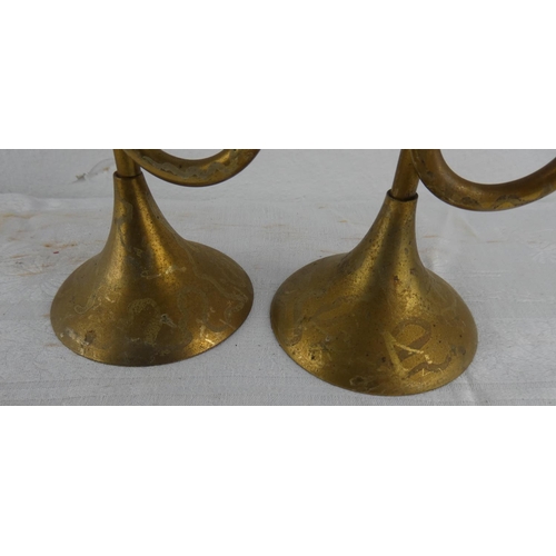 116 - An unusual pair of brass trumpet style candlesticks.