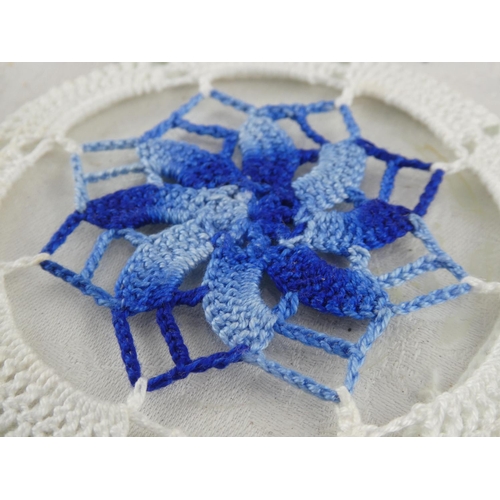 64 - A set of four vintage embroidered coasters.