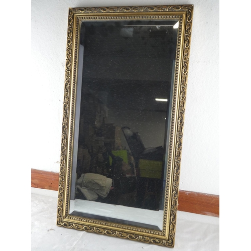 68 - A gilt framed rectangular wall mirror. (measuring 66x35cm).