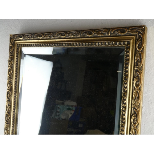 68 - A gilt framed rectangular wall mirror. (measuring 66x35cm).