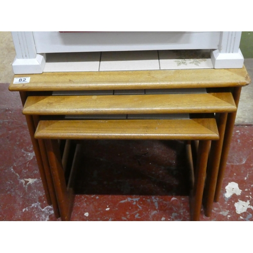 82 - A set of three vintage tiled topped nest of tables.
