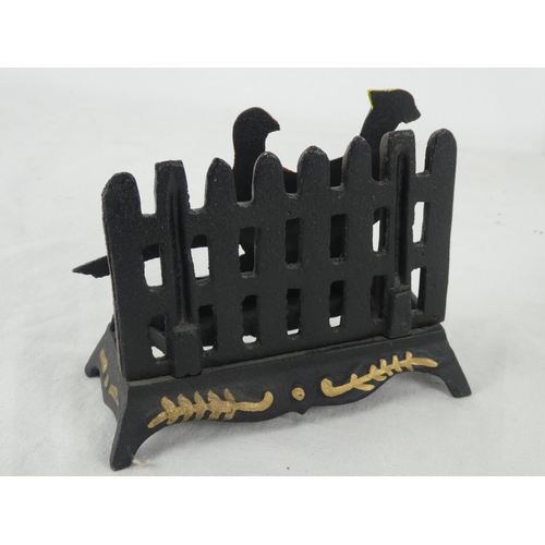 13 - A decorative cast iron letter rack.
