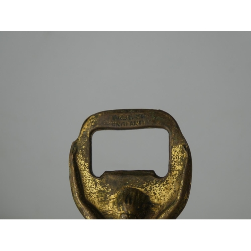 21 - A vintage novelty brass bottle opener.