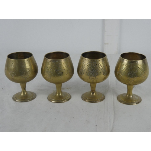 68 - A set of four brass goblets.