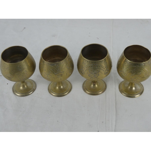 68 - A set of four brass goblets.