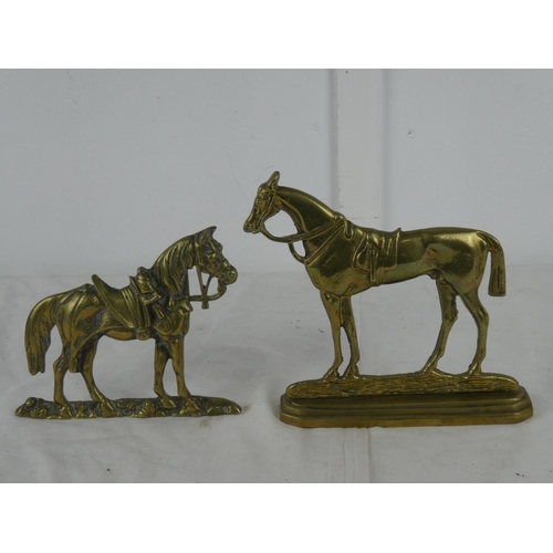 76 - Two brass horse ornaments.