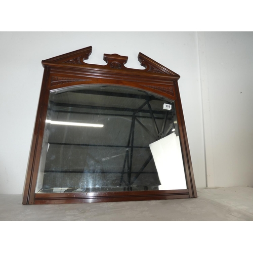 468 - An antique carved mirror with bevelled glass.