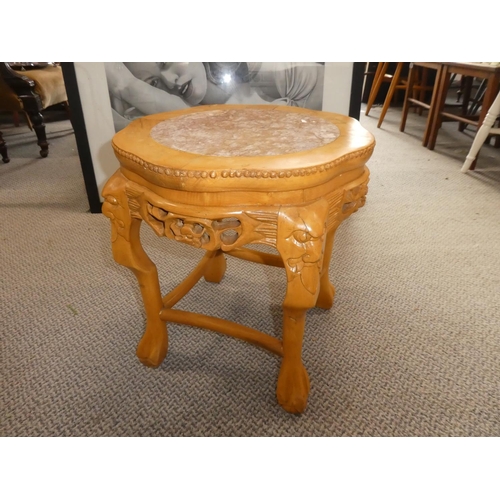 475 - A marble topped table with carved detail.