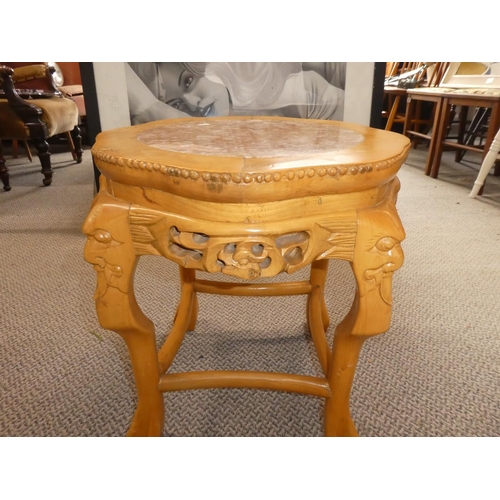 475 - A marble topped table with carved detail.