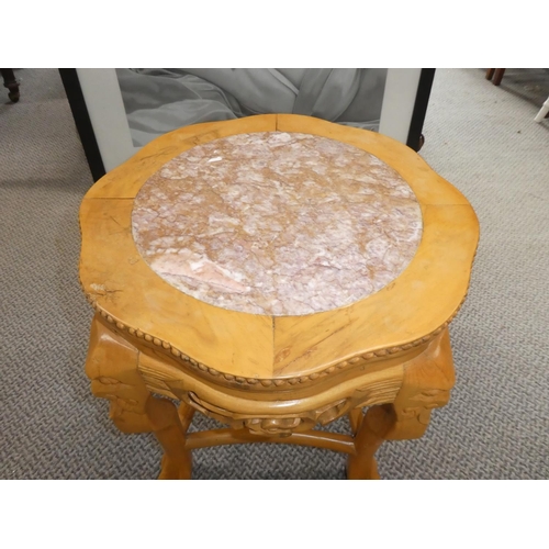 475 - A marble topped table with carved detail.