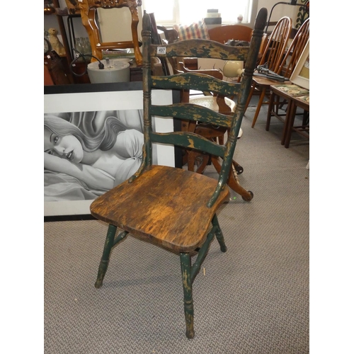 497 - An antique kitchen chair.