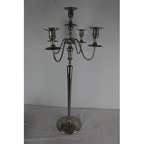 507 - A silver metal four branch candelabra measuring 80cm tall.