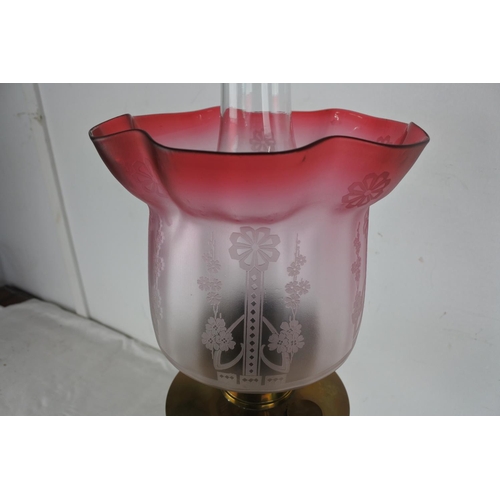 517 - An antique brass based oil lamp and etched glass shade.